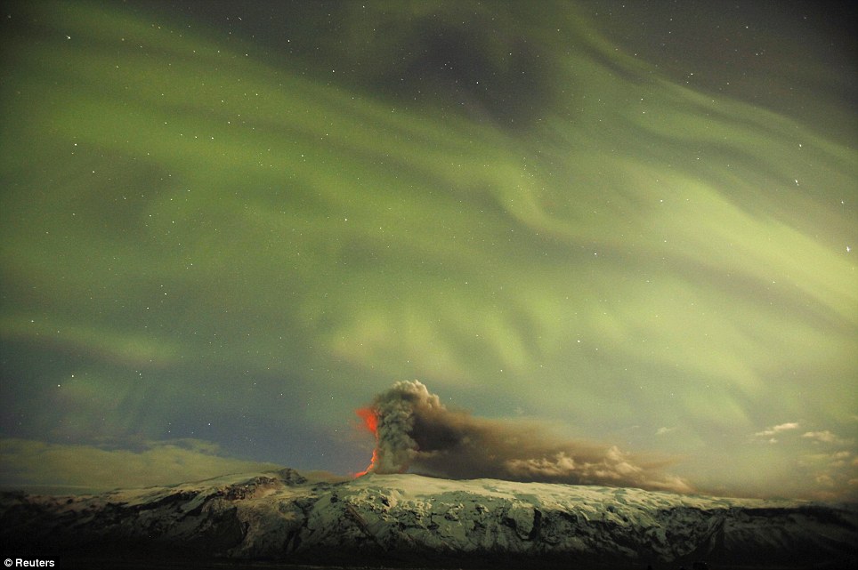 Beauty and Power Collide as Northern Lights Glow Over Volcano.